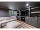 Finished basement featuring gray cabinets, a large TV, recessed lighting, and a gray couch with ottoman at 305 Montevallo Dr, Atlanta, GA 30342