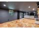 Spacious basement with tile flooring, recessed lights, and a comfortable seating area with a large TV and fireplace at 305 Montevallo Dr, Atlanta, GA 30342