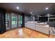 A large gray sectional couch in a finished basement with recessed lighting and access to the backyard at 305 Montevallo Dr, Atlanta, GA 30342