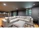 Open basement area featuring a large sectional couch, recessed lights, and a beverage bar area at 305 Montevallo Dr, Atlanta, GA 30342