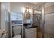 Cozy bathroom featuring a glass door shower, sink, vanity, and storage cabinet for a comfortable experience at 305 Montevallo Dr, Atlanta, GA 30342