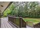 Spacious wooden deck and steps lead down to the backyard, perfect for outdoor entertaining at 305 Montevallo Dr, Atlanta, GA 30342