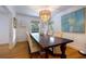 Elegant dining room featuring a wooden table, stylish chandelier, and large windows offering natural light at 305 Montevallo Dr, Atlanta, GA 30342