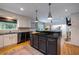 Bright kitchen featuring black countertops, stainless appliances and view to the living space at 305 Montevallo Dr, Atlanta, GA 30342