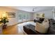 Spacious living room featuring a comfortable leather couch and access to an outdoor deck through glass doors at 305 Montevallo Dr, Atlanta, GA 30342