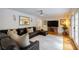 Inviting living room with a plush leather couch, large screen TV, and warm lighting, perfect for relaxation at 305 Montevallo Dr, Atlanta, GA 30342