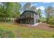 Backyard view of home exterior, featuring a tiered deck and patio and lush green grass at 3165 Brookview Dr, Marietta, GA 30068