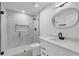 Modern bathroom featuring a marble shower, sleek black fixtures, and an oval mirror above the vanity at 3165 Brookview Dr, Marietta, GA 30068