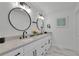 Elegant bathroom featuring a double sink vanity with round mirrors and marble countertops at 3165 Brookview Dr, Marietta, GA 30068