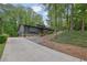 Contemporary home featuring a stylish exterior, two-car garage, landscaped front yard, and a lengthy concrete driveway at 3165 Brookview Dr, Marietta, GA 30068