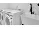 Functional laundry room featuring a sink, modern washer and dryer at 3165 Brookview Dr, Marietta, GA 30068