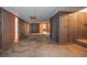 Unfinished basement with concrete floor, wood paneled walls, multiple storage rooms, and closets at 3916 Ridgewood Se Dr, Smyrna, GA 30080