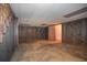 Basement with concrete floor, wood paneled walls, shelving, and access to utility room at 3916 Ridgewood Se Dr, Smyrna, GA 30080