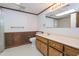 Bathroom with wood paneled walls, single vanity, framed mirror, and tile flooring at 3916 Ridgewood Se Dr, Smyrna, GA 30080