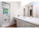 Bathroom with white vanity, large mirror, tiled shower and window with natural light at 3916 Ridgewood Se Dr, Smyrna, GA 30080