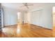 Bright bedroom features hardwood floors, ceiling fan, closet with bi-fold doors, and white walls at 3916 Ridgewood Se Dr, Smyrna, GA 30080
