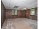 Bedroom with carpet, wood paneled walls, drop ceiling, and two windows at 3916 Ridgewood Se Dr, Smyrna, GA 30080