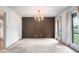 The dining room features white walls, a dark accent wall and dated draperies and carpeting at 3916 Ridgewood Se Dr, Smyrna, GA 30080