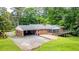 Aerial view of brick ranch home with carport, screened-in porch, deck, and large yard at 3916 Ridgewood Se Dr, Smyrna, GA 30080