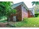 A brick exterior shows the side of the house with foliage growing close to the building at 3916 Ridgewood Se Dr, Smyrna, GA 30080