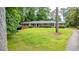 A sprawling front yard leads up to a brick home with a long, covered front porch at 3916 Ridgewood Se Dr, Smyrna, GA 30080