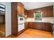 Traditional kitchen with wood cabinets, white appliances and countertops, and hardwood floors at 3916 Ridgewood Se Dr, Smyrna, GA 30080