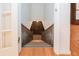 Staircase leading to the basement from main floor with wooden banister and white risers at 3916 Ridgewood Se Dr, Smyrna, GA 30080