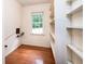 A storage room with wooden floors boasts white shelves and a window that lets in natural light at 3916 Ridgewood Se Dr, Smyrna, GA 30080