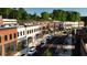 Charming street view of mixed-use development with shops, restaurants, and brick facade buildings and beautiful landscaping at 4850 Summerchase Ln, Cumming, GA 30028