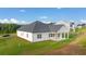 Expansive backyard with lush green grass, and a covered patio at 648 Kimberwick Dr, Locust Grove, GA 30248