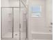 Bathroom featuring a glass shower and a soaking tub at 648 Kimberwick Dr, Locust Grove, GA 30248