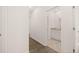 Hallway featuring hardwood floors and an open doorway to a bathroom at 648 Kimberwick Dr, Locust Grove, GA 30248