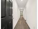 Inviting hallway with wood-look floors leads to a bright, open living space at 648 Kimberwick Dr, Locust Grove, GA 30248