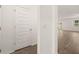Hallway featuring hardwood floors and an entrance doorway to a living room at 648 Kimberwick Dr, Locust Grove, GA 30248