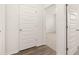 Hallway featuring hardwood floors and doorways to bedrooms at 648 Kimberwick Dr, Locust Grove, GA 30248