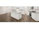 Modern, spacious kitchen features an island, stainless appliances, granite countertops, and wood-look floors at 648 Kimberwick Dr, Locust Grove, GA 30248