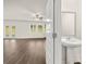 View of the living room with modern kitchen, fireplace, and powder room at 648 Kimberwick Dr, Locust Grove, GA 30248