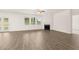 Open living room with a cozy fireplace, and large windows for natural light at 648 Kimberwick Dr, Locust Grove, GA 30248