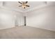 A spacious main bedroom with trey ceilings and carpet flooring at 648 Kimberwick Dr, Locust Grove, GA 30248
