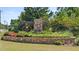 Stone monument sign with the name of the community surrounded by beautiful plants at 648 Kimberwick Dr, Locust Grove, GA 30248