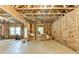 Unfinished basement with exposed beams and insulation offers potential for customization and added living space at 12095 Cameron Dr, Duluth, GA 30097
