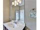 Bathroom featuring a white vanity, framed mirror, and modern light fixture for a refreshing space at 12095 Cameron Dr, Duluth, GA 30097