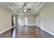 Spacious bedroom boasting hardwood floors, tray ceiling, and a ceiling fan at 12095 Cameron Dr, Duluth, GA 30097