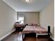 This bedroom features wood floors, neutral walls, and a cozy bed with a small desk by the window at 12095 Cameron Dr, Duluth, GA 30097