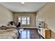 Spacious bedroom featuring hardwood floors, neutral walls, and a window providing natural light at 12095 Cameron Dr, Duluth, GA 30097