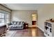 Bedroom featuring hardwood floors, a grey couch, and ensuite bathroom at 12095 Cameron Dr, Duluth, GA 30097