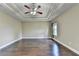 Spacious bedroom featuring hardwood floors, tray ceiling, and a ceiling fan at 12095 Cameron Dr, Duluth, GA 30097