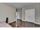 Spacious bedroom with hardwood flooring, white trim, closet, and a view through to the hallway at 12095 Cameron Dr, Duluth, GA 30097