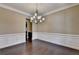 Open dining area featuring dark hardwood floors and a modern lighting fixture at 12095 Cameron Dr, Duluth, GA 30097