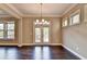 Dining room with dark hardwood floors and French doors leading to an outdoor deck at 12095 Cameron Dr, Duluth, GA 30097
